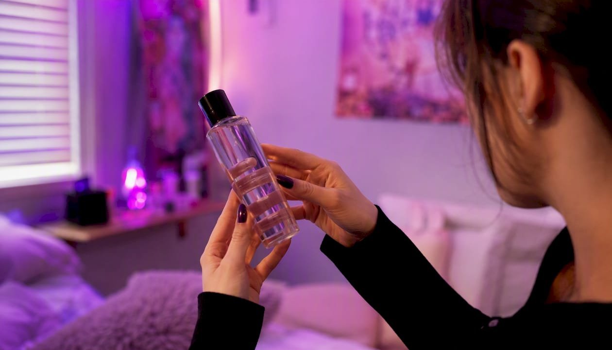 Hands reading lube ingredient label