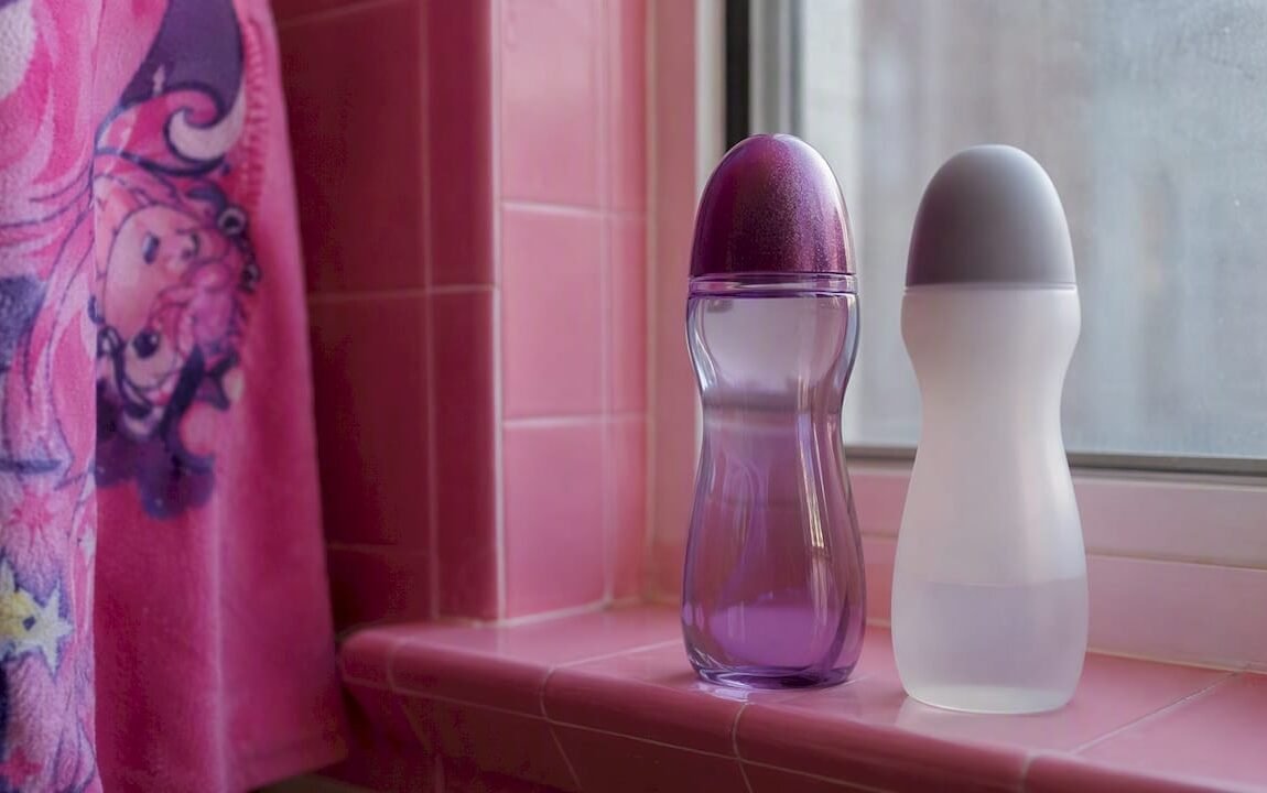 Two generic lube bottles on bathroom shelf