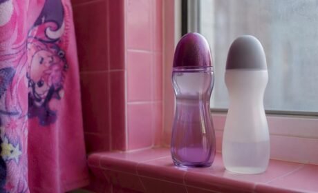 Two generic lube bottles on bathroom shelf